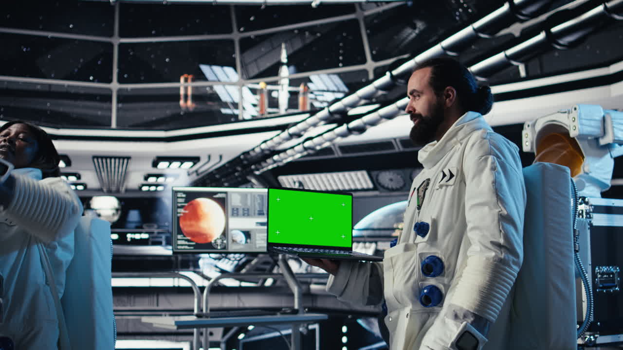 Astronauts check human expansion in space mission logs on mockup laptop