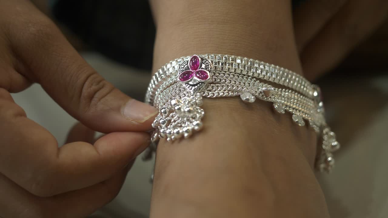 Indian female customer wearing silver anklet, silver jewelry, Closeup