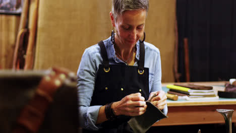 craftswoman working on a piece of leather