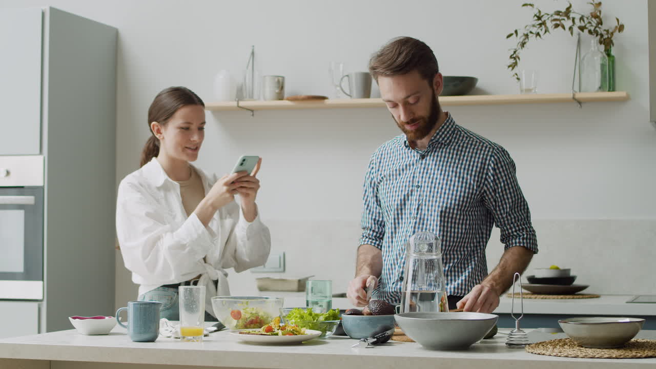 Happy Couple Preparing Food At Home