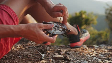 setting up a portable camp stove on a mountain hike