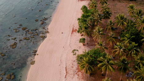 sunset golden hour on beach colourful red orange sun blue sea and white sand in asia with drone