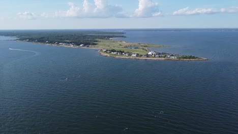 Flying-over-seawater-looking-at-peninsula