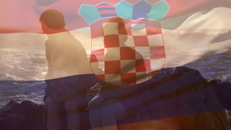 animation of flag of croatia over caucasian parents with child at beach