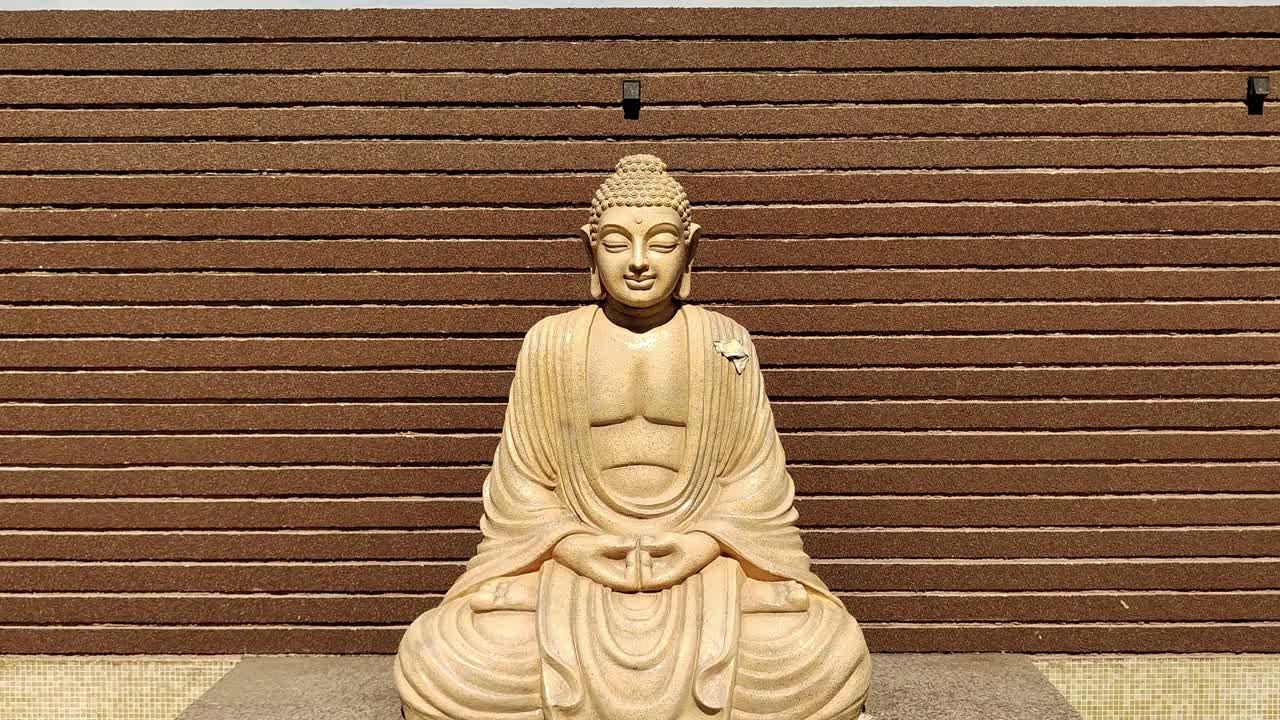 Tranquil 4K stock footage of Buddha statue in peaceful setting, symbolizing meditation, mindfulness and spiritual serenity. Ideal for yoga, wellness, relaxation and inspired visuals.