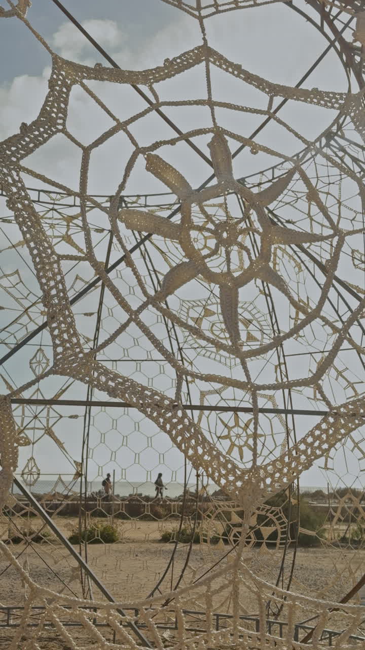 woven art pattern by the beach in barcelona in vertical