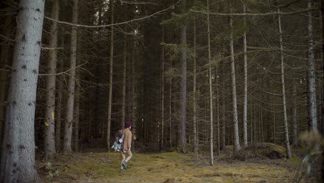 Female-explorer-with-backpack-walking-by-trees