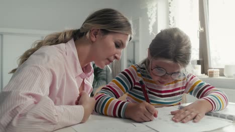 Mother-helping-daughter-in-doing-homework