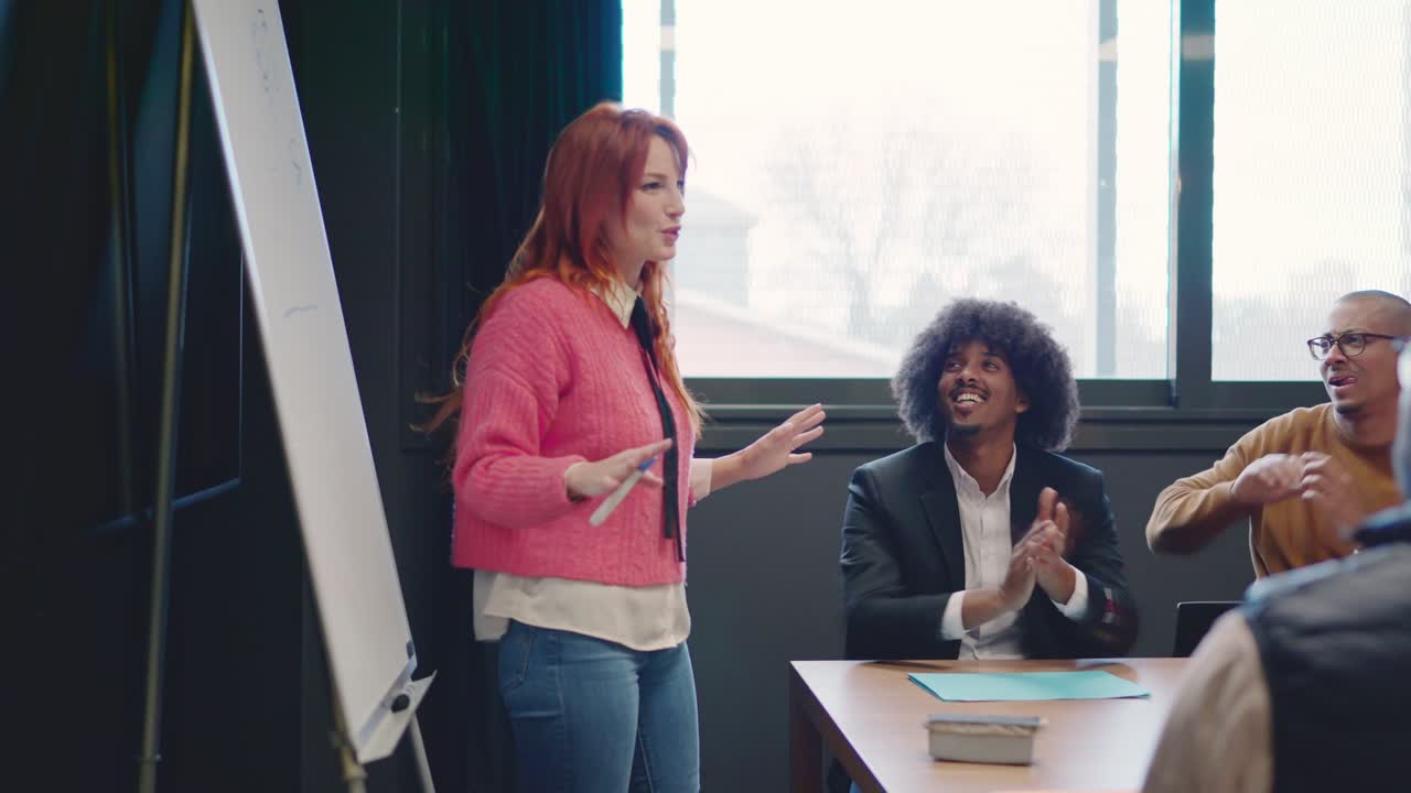 Coworkers applauding and congratulate a woman after a speech