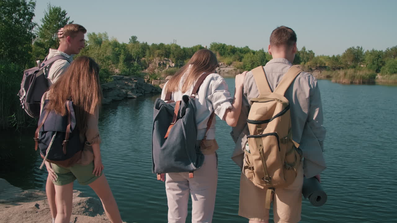 Young People with Backpacks Enjoying Scenery