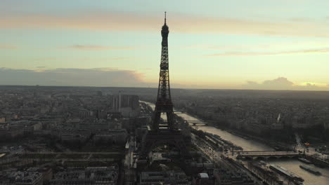 Aerial-panoramic-footage-of-city-at-twilight.-Famous-and-tall-Eiffel-Tower-in-foreground.-Paris,-France