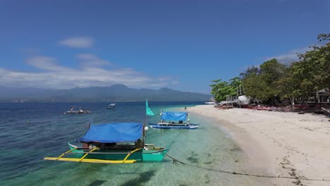 discovering the enchantment of the philippines: idyllic beaches, traditional boats, azure skies, majestic mountains, and the vibrant hues of the sea - a tapestry of unrivaled beauty