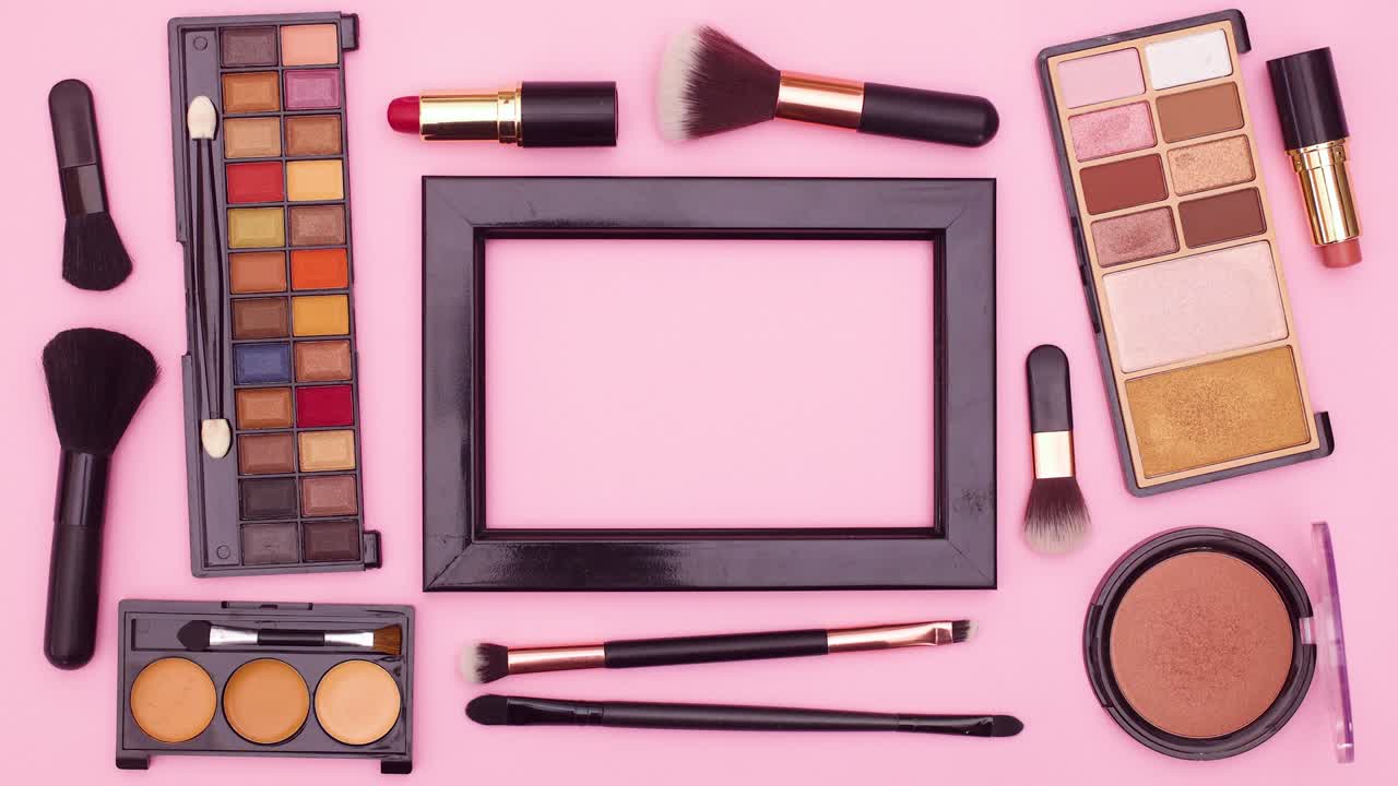Make up products move around black frame for text on pink theme. Stop motion