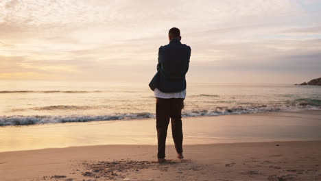 Beach,-man-spinning-child-and-playful-sunset