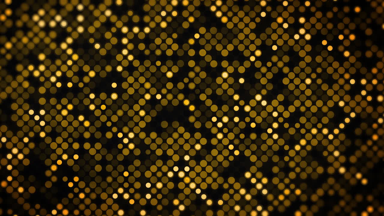 Yellow glowing circles and dots of various sizes forming a shimmering grid texture. Loop animation. Golden bokeh dot grid on black background