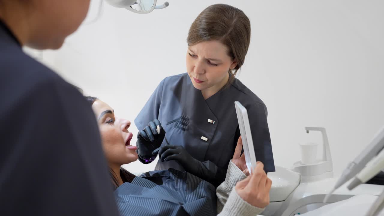 Dentist Examining Patient in Dental Office