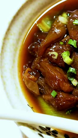 a savory beef stew garnished with fresh herbs