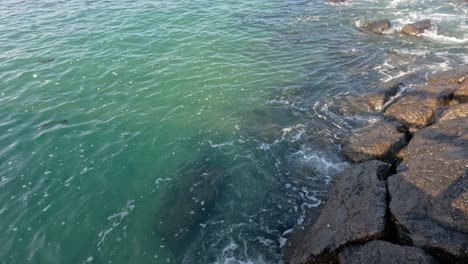 gentle waves hitting rocks at port phillip bay