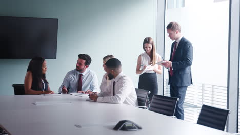 Group-Collaborating-On-Task-At-Graduate-Recruitment-Assessment-Day-Whilst-Being-Observed-By-Recruitment-Team