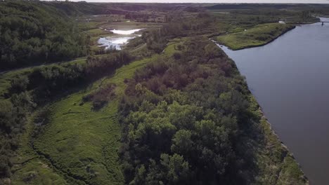 lush aerial of vivid green prairie river valley wetland marsh