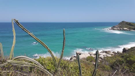 Pan-shot-over-stunning-turquoise-colored-beach-water-in-the-Tayrona-National-Natural-Park,-Colombia