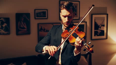 man playing violin at home