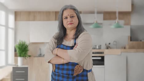 portrait of indian aged housewife standing crossed hands