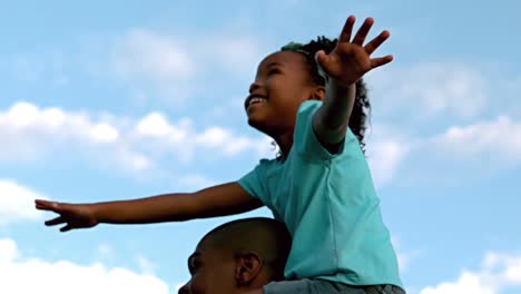 father giving his daughter a piggy back