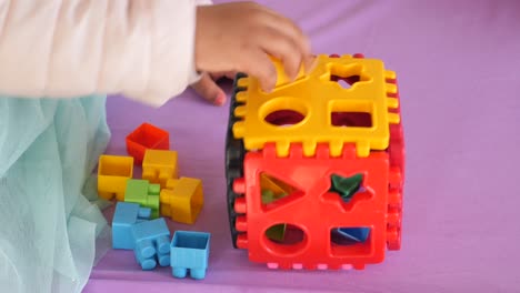 child playing with shape sorter toys