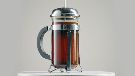 modern coffee french press, spinning against grey background