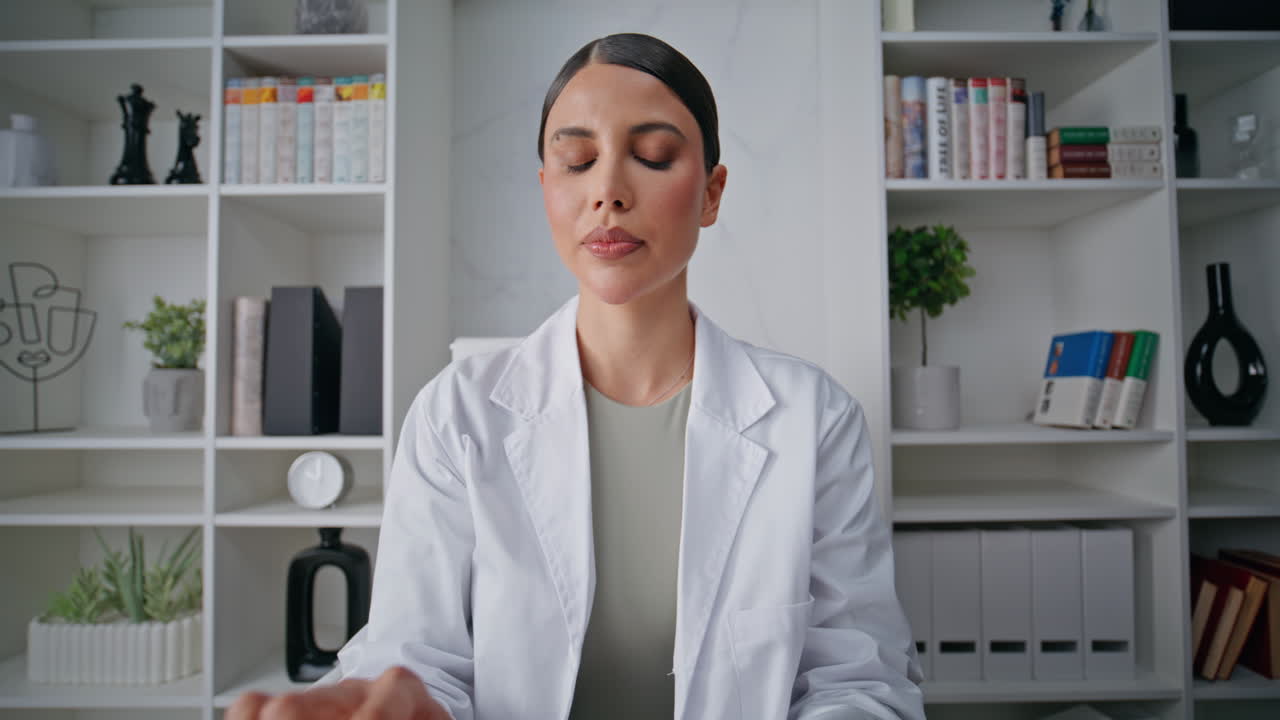 Telehealth expert speaking online by computer webcam in clinic office pov video