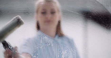 cleaning woman cleaning window with detergents 1