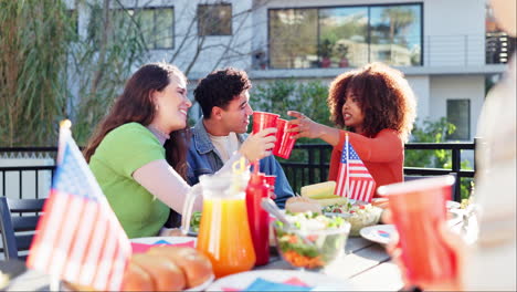 Friends celebrating with food and drinks on a patio