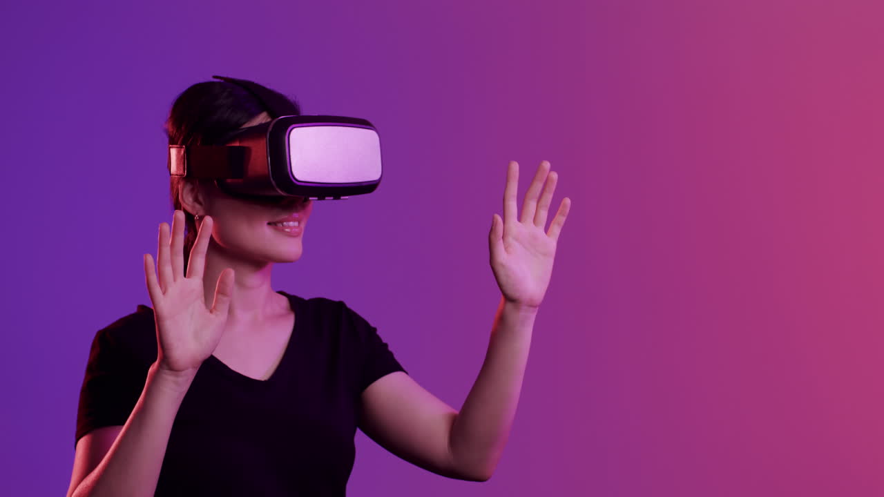 Asian woman using vr headset, touching screen on purple background, copy space, slow motion