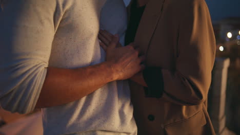 Closeup couple hands connecting on evening date. Loving man gently touching girl