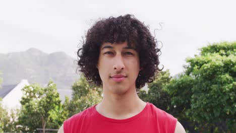 Video-portrait-of-happy-biracial-man-smiling-to-camera-outdoors