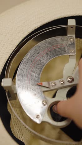 measuring hat size with a hat block