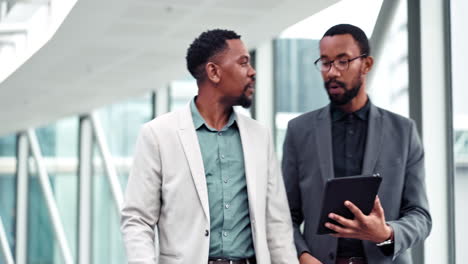 business men, walking and talking about tablet