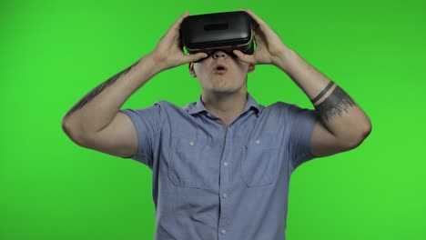 man using vr app helmet to play simulation game, drawing. guy watching virtual reality 3d video