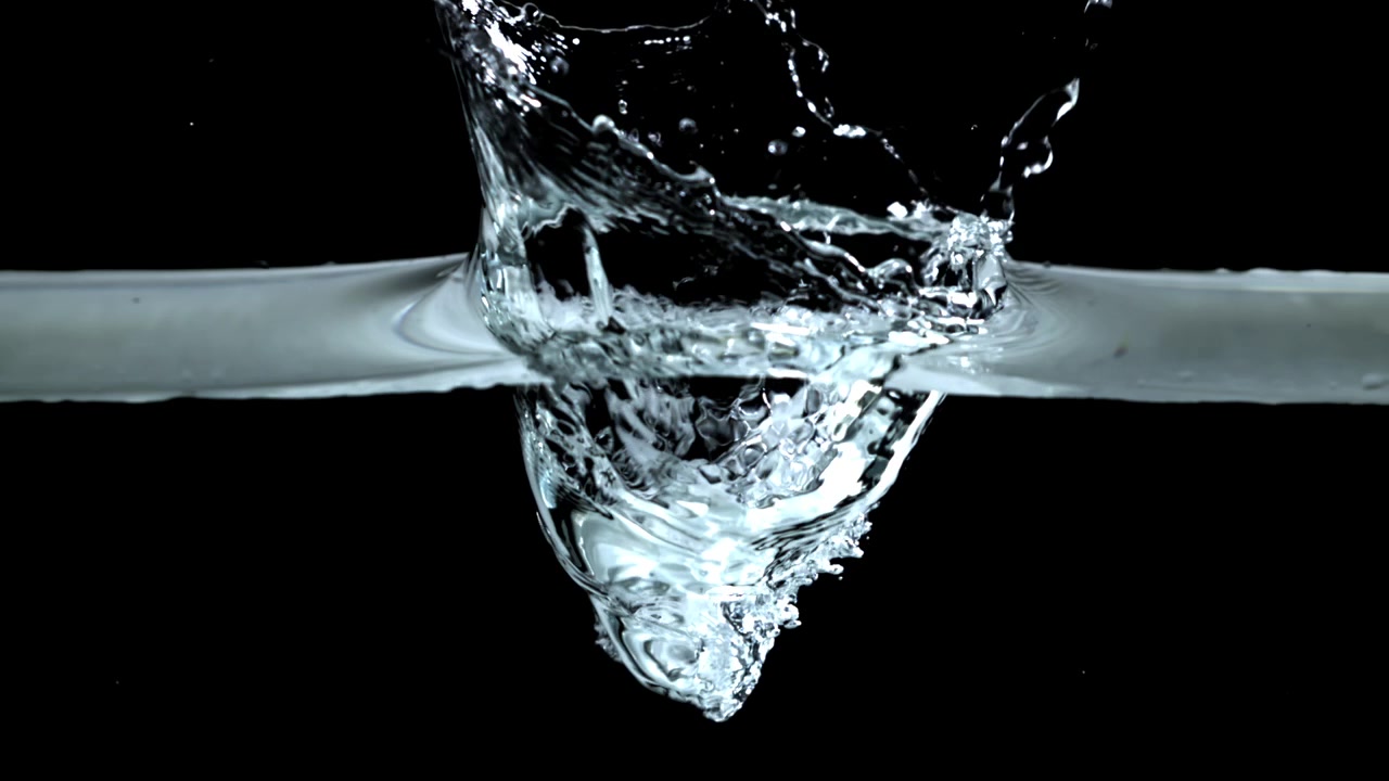 Slow Motion Clear Water Pouring and Splashing on Black Background
