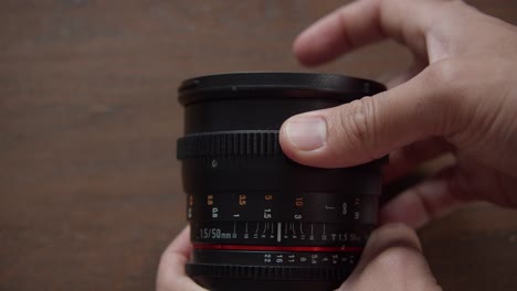 Photographer's-Hand-Rotating-Distance-Focusing-Ring-To-Focus-The-Image