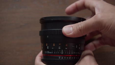 photographer's hand rotating distance focusing ring to focus the image