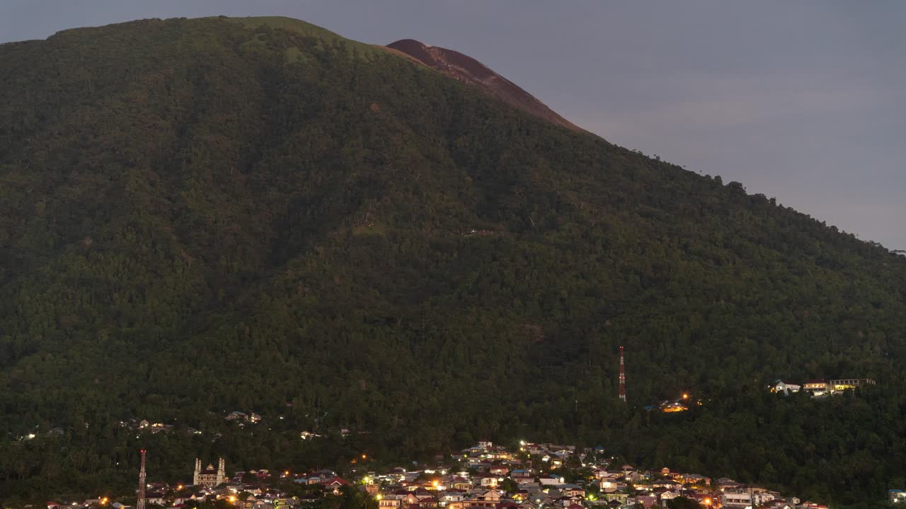 Views of a Town Nestled at the Base of a Volcanic Mountain