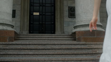woman in a white dress on the steps of a historical building