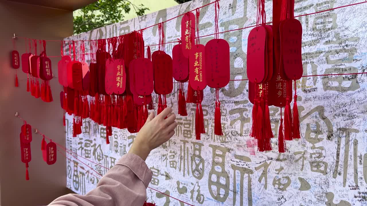 Checking lucky red charms at Yu Garden, Shanghai