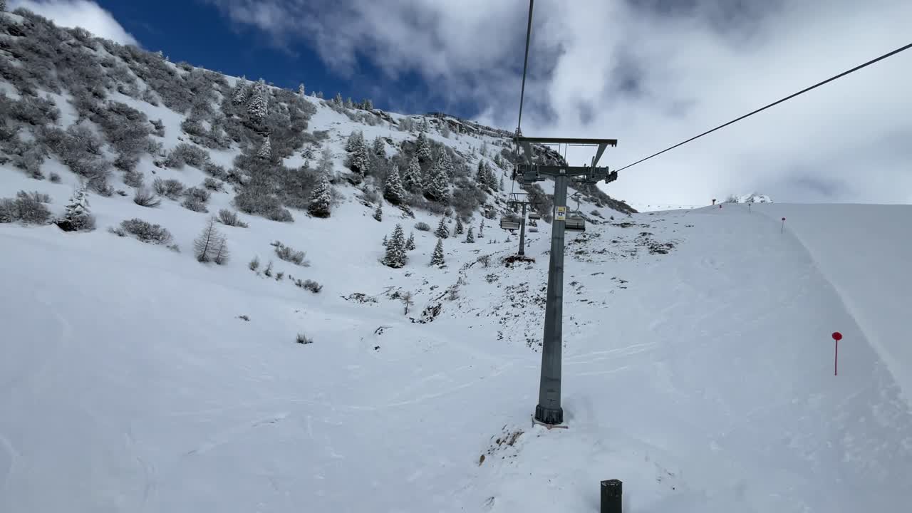 Snowy alpine landscape seen from ski chairlift in Kappl, Tyrol.