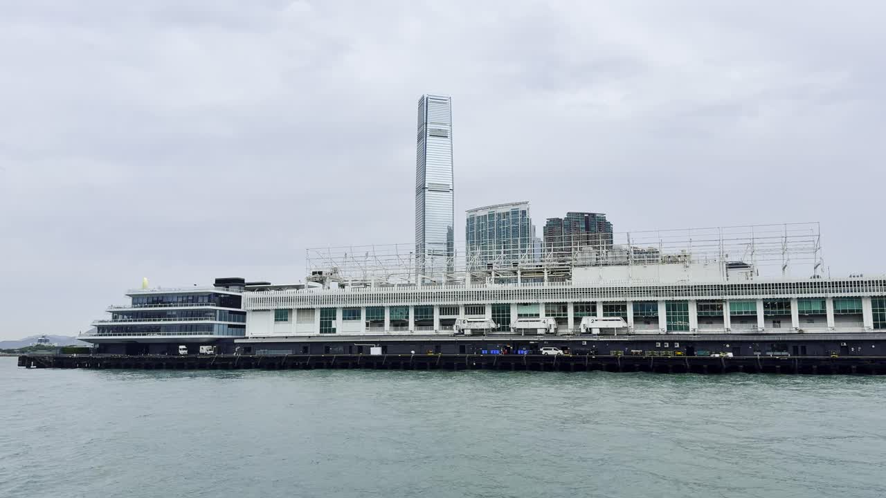 Footage captured from a ferry in Hong Kong, showcasing the city skyline, bustling harbor, moving vessels, and waterfront activity, highlighting the dynamic energy and scenic beauty of Victoria Harbour