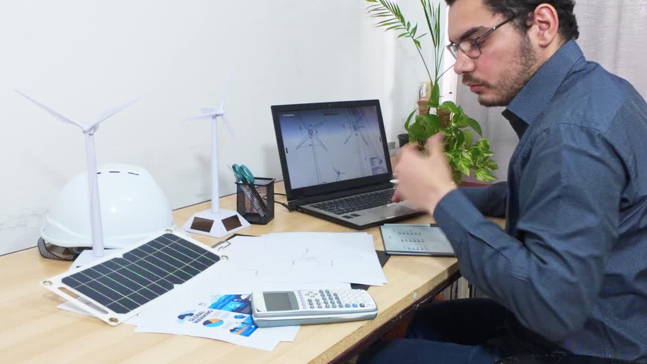 Stressed Engineer Working Late on a Complex Renewable Energy Project