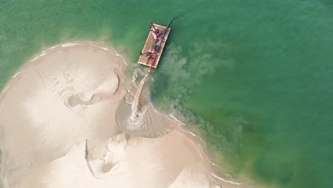 panning and tilting around a barge doing dredge work in summer