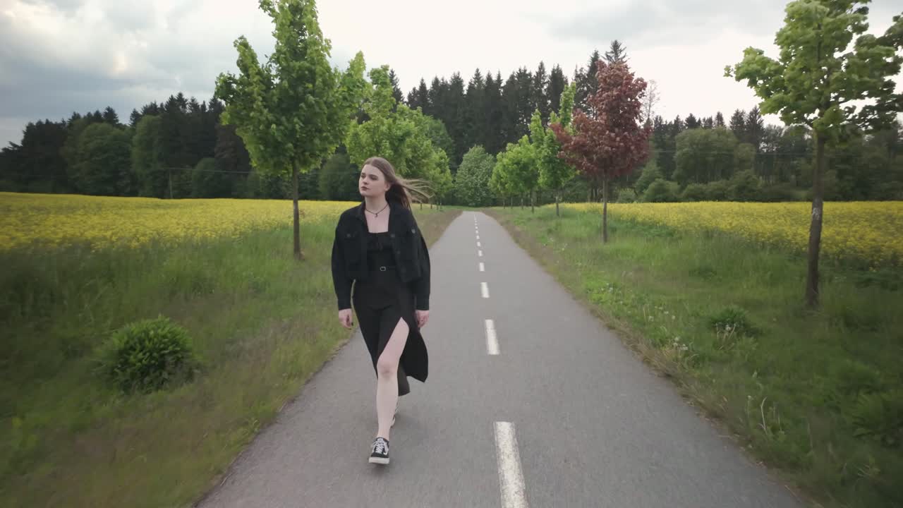 Wind weht durch ihr Haar, junge Frau auf einer Wanderung auf dem Land